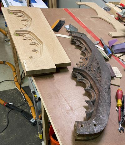 Original dark oak Gothic arch header beside new white oak hand-carved replication — Montgomery County PA