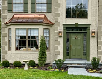 Copper bay window with warm interior lighting at twilight, Montgomery County PA