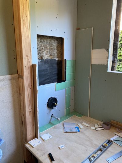 Tile installation in progress — vintage green tile application