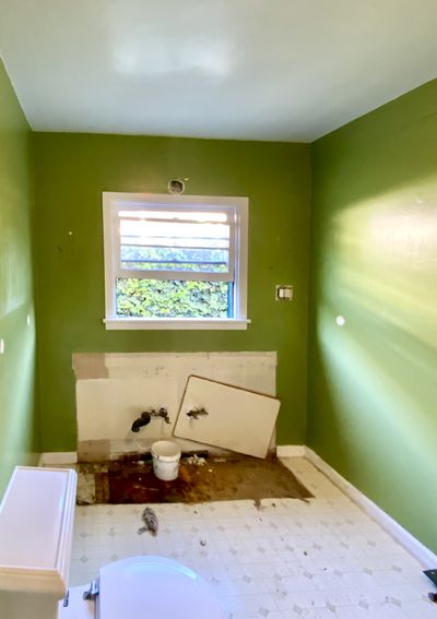 Bathroom before renovation — outdated fixtures and dated tile