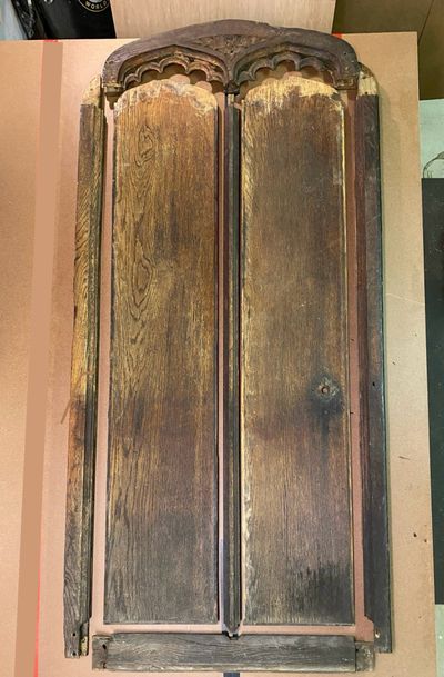 Antique Gothic double door disassembled for historic restoration assessment