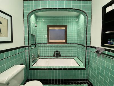 Vintage green tile bathroom renovation with arched tub alcove and period fixtures — Fred Beese Builds