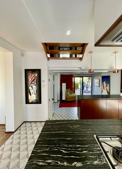 Dark marble kitchen countertop with copper pendant lighting