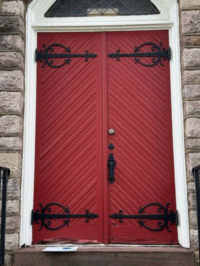 Historic chapel door with rot damage at base before restoration — Montgomery County PA