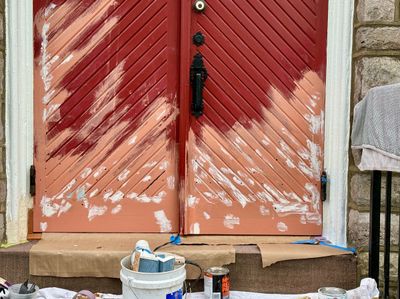Door painting in progress with original iron hardware detail visible — Fort Washington PA